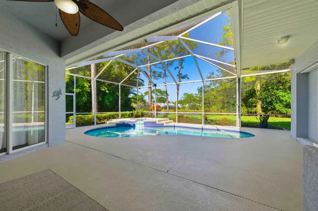 an aerial view of a house with a yard and lake view
