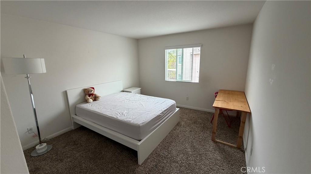 7134 Cumberland Place Rancho Cucamonga, CA 91739 - Photo 17 of 22 a bed sitting in a bedroom next to a window
