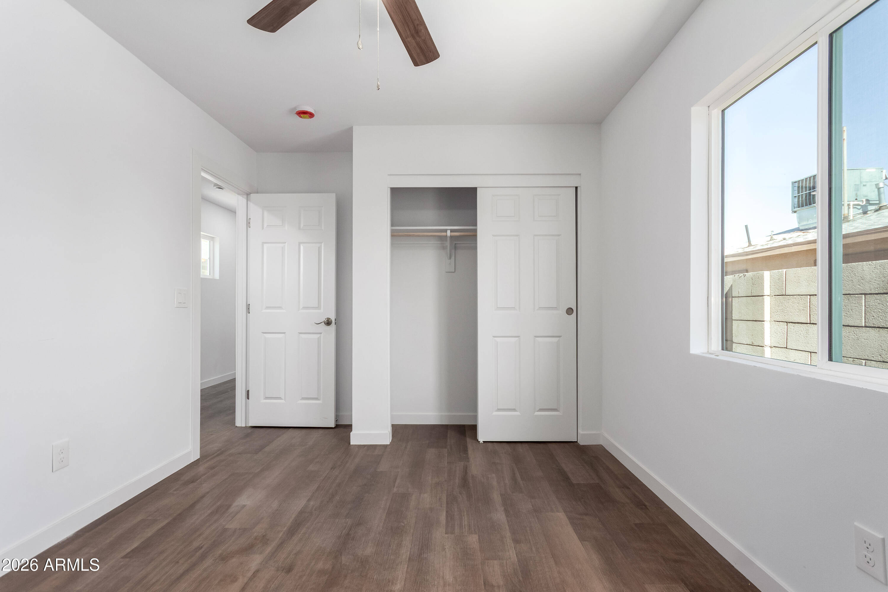 9155 West Adams Street Tolleson, AZ 85353 - Photo 1 of 29 an empty room with windows and closet