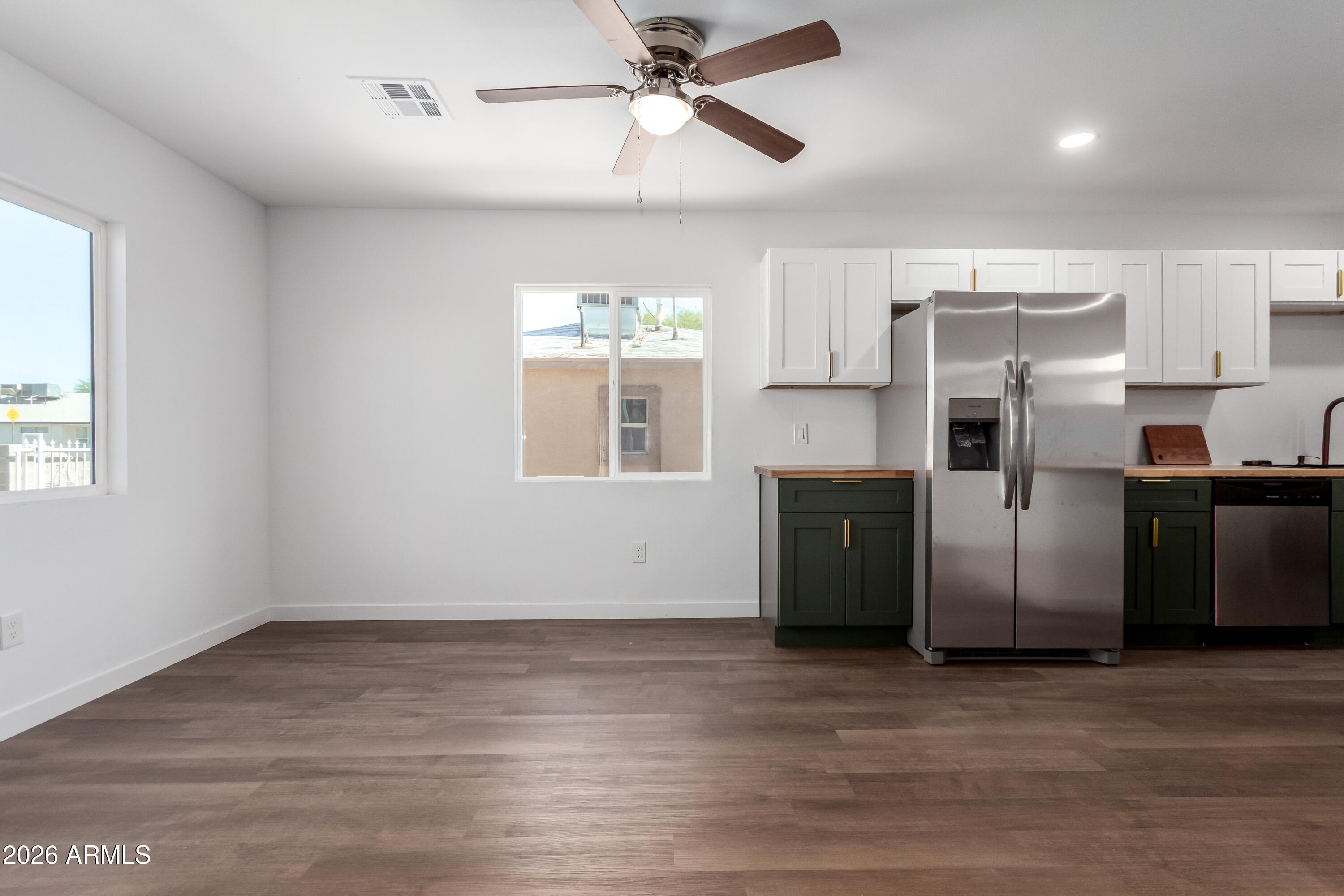 9155 West Adams Street Tolleson, AZ 85353 - Photo 11 of 29 a kitchen with stainless steel appliances a refrigerator and a chandelier
