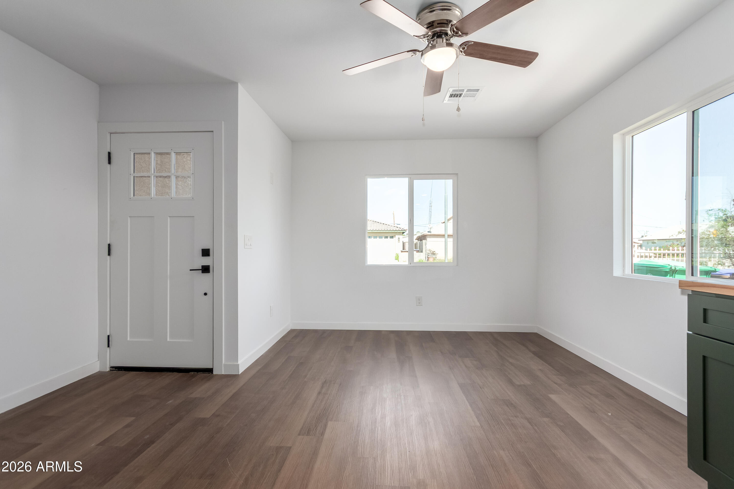 9155 West Adams Street Tolleson, AZ 85353 - Photo 12 of 29 wooden floor in an empty room with a window