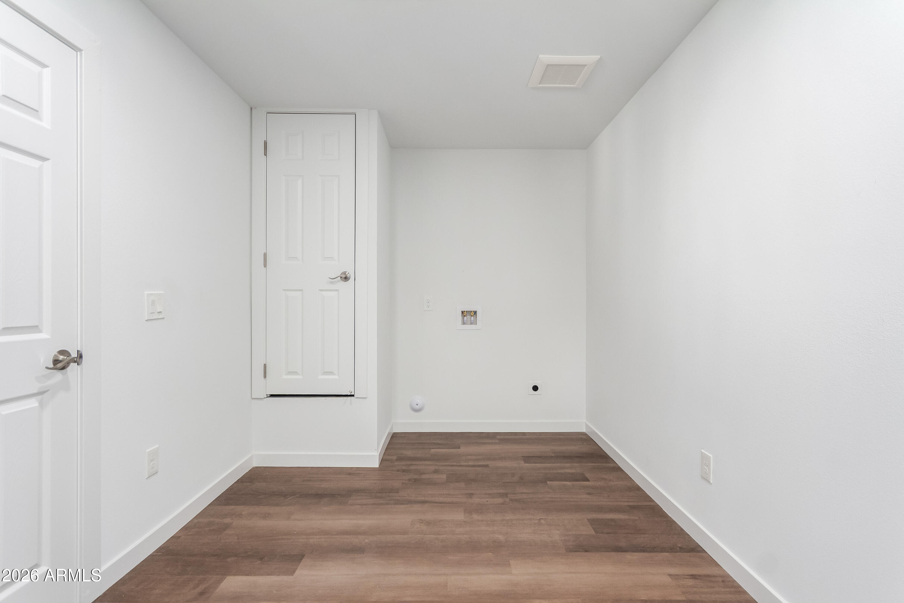 9155 West Adams Street Tolleson, AZ 85353 - Photo 14 of 29 a view of empty room with wooden floor