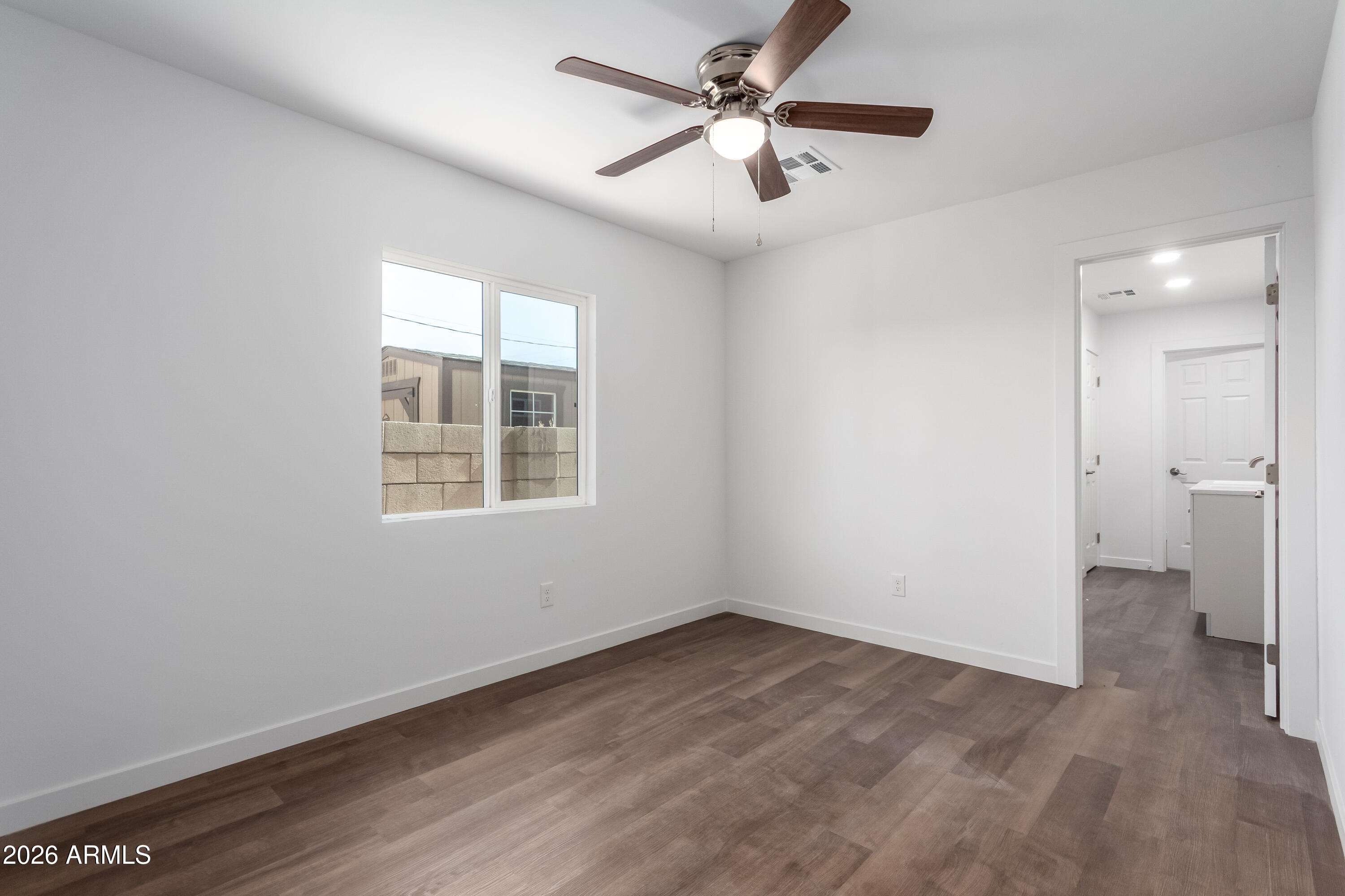 9155 West Adams Street Tolleson, AZ 85353 - Photo 16 of 29 a view of empty room with wooden floor