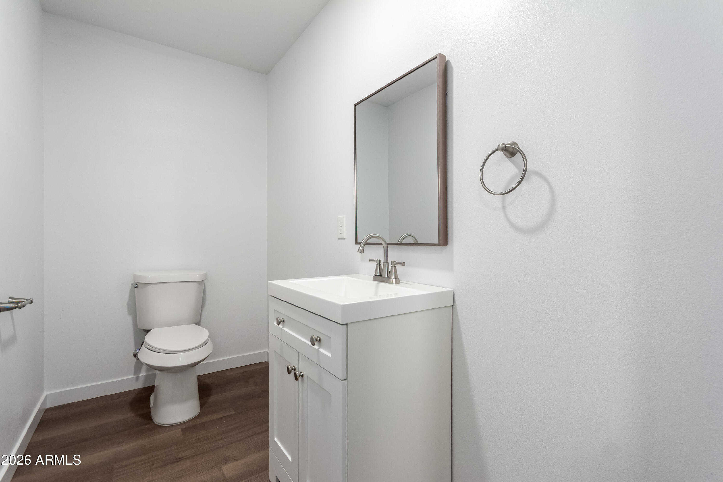 9155 West Adams Street Tolleson, AZ 85353 - Photo 23 of 29 a bathroom with a toilet sink and mirror