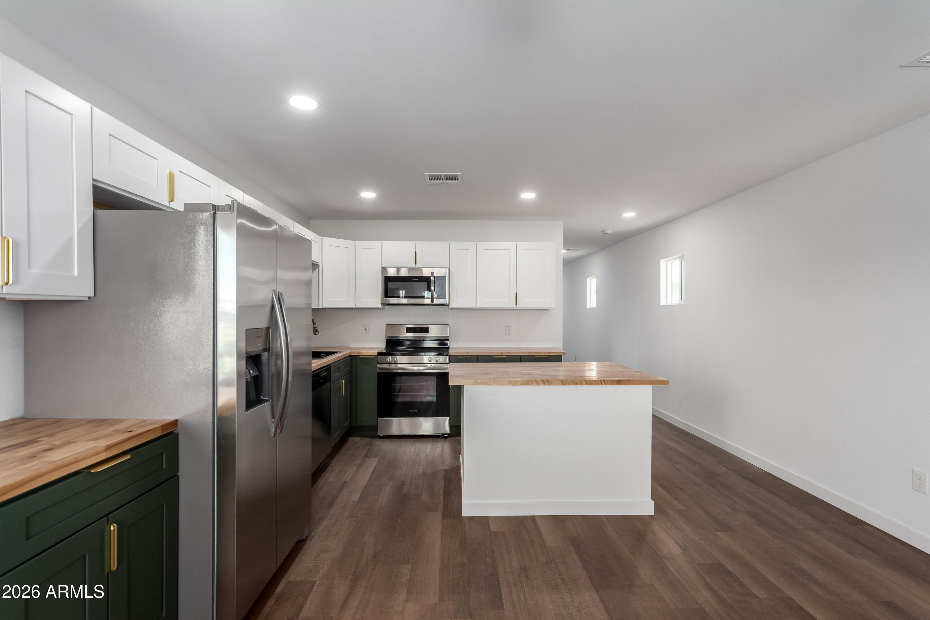 9155 West Adams Street Tolleson, AZ 85353 - Photo 5 of 29 a kitchen with stainless steel appliances a sink stove and refrigerator