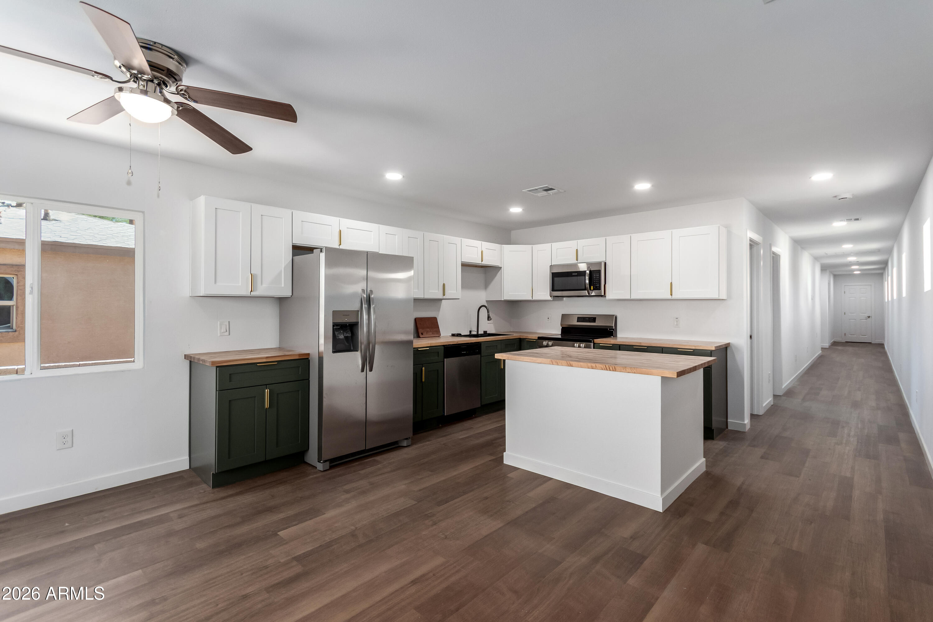 9155 West Adams Street Tolleson, AZ 85353 - Photo 6 of 29 a kitchen with a refrigerator and a stove top oven