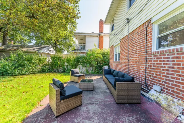 a view of a patio with couches and pool