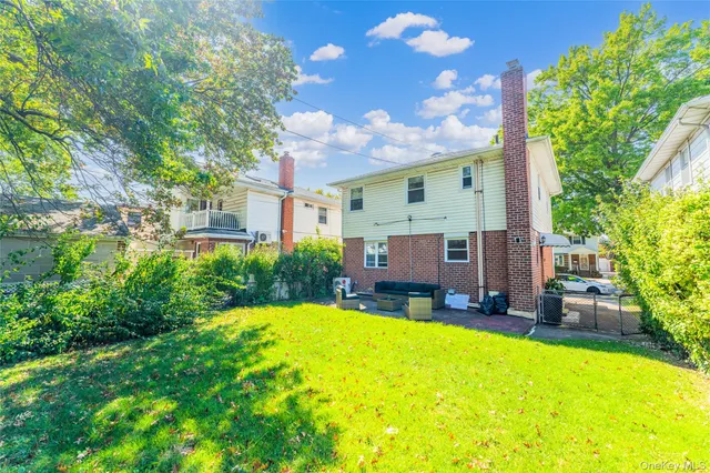 a view of a house with a big yard and potted plants