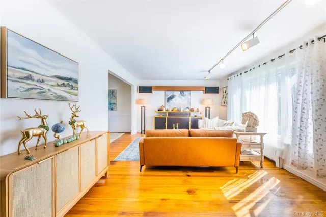 a living room with furniture a fireplace and a large window