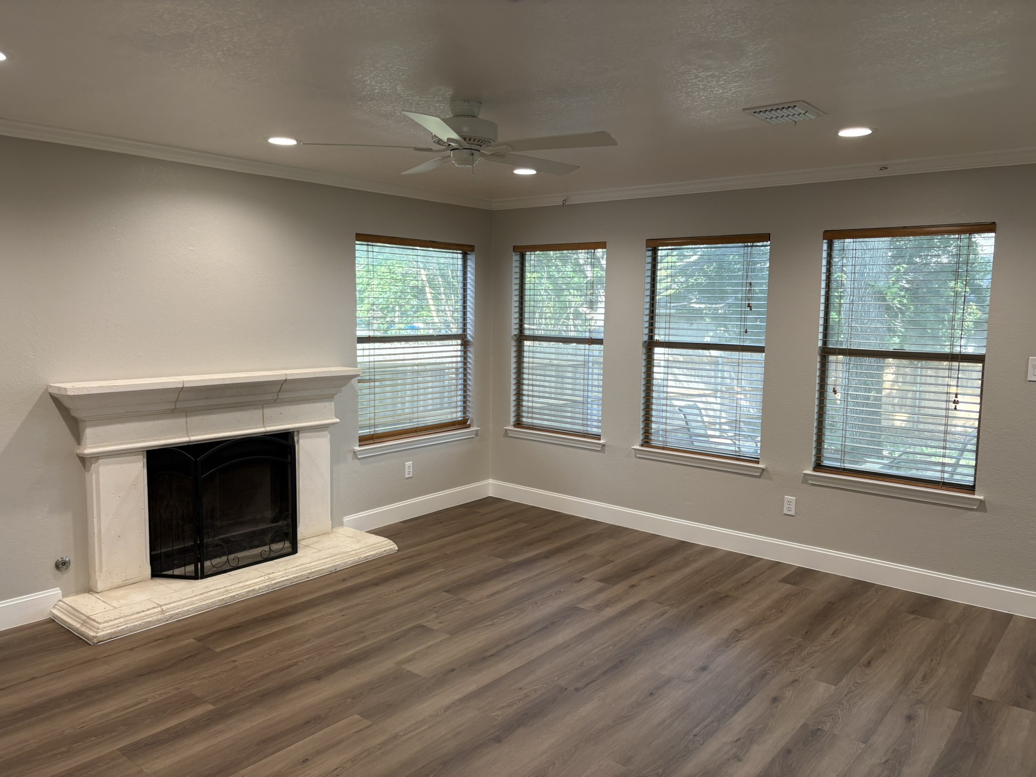 14707 Single Trace Austin, TX 78728 - Photo 10 of 17 A refined living area boasts a classic fireplace and lustrous wood flooring.