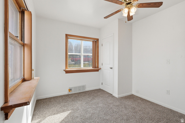 871 North 700 East Logan, UT 84321 - Photo 9 of 20 Carpeted empty room with baseboards and a ceiling fan
