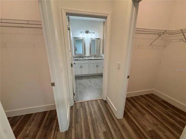 a bathroom with a double vanity sink toilet and mirror