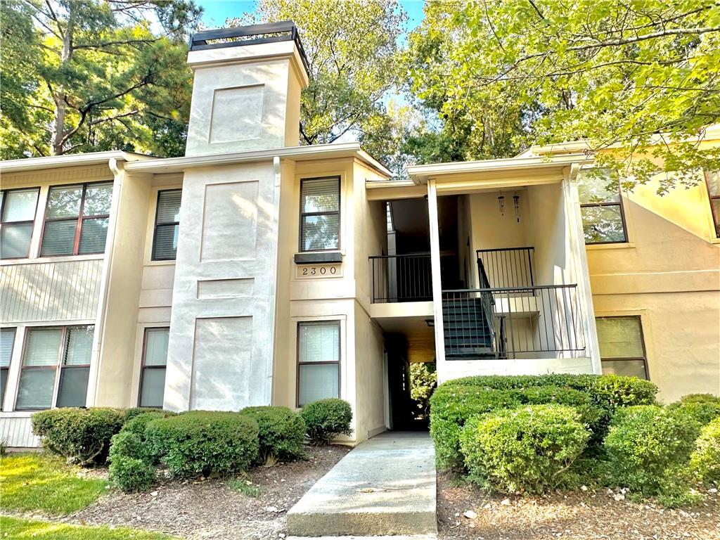 2301 Huntingdon Chase Atlanta, GA 30350 - Photo 13 of 15 a front view of a house with a garden
