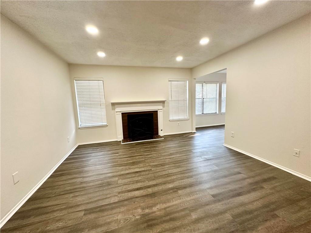 2301 Huntingdon Chase Atlanta, GA 30350 - Photo 5 of 15 an empty room with wooden floor and fireplace