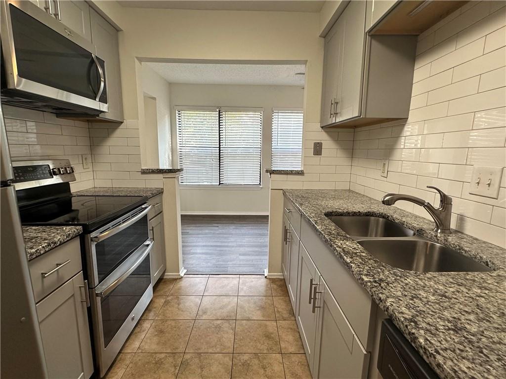2301 Huntingdon Chase Atlanta, GA 30350 - Photo 6 of 15 a kitchen with a sink stove and microwave