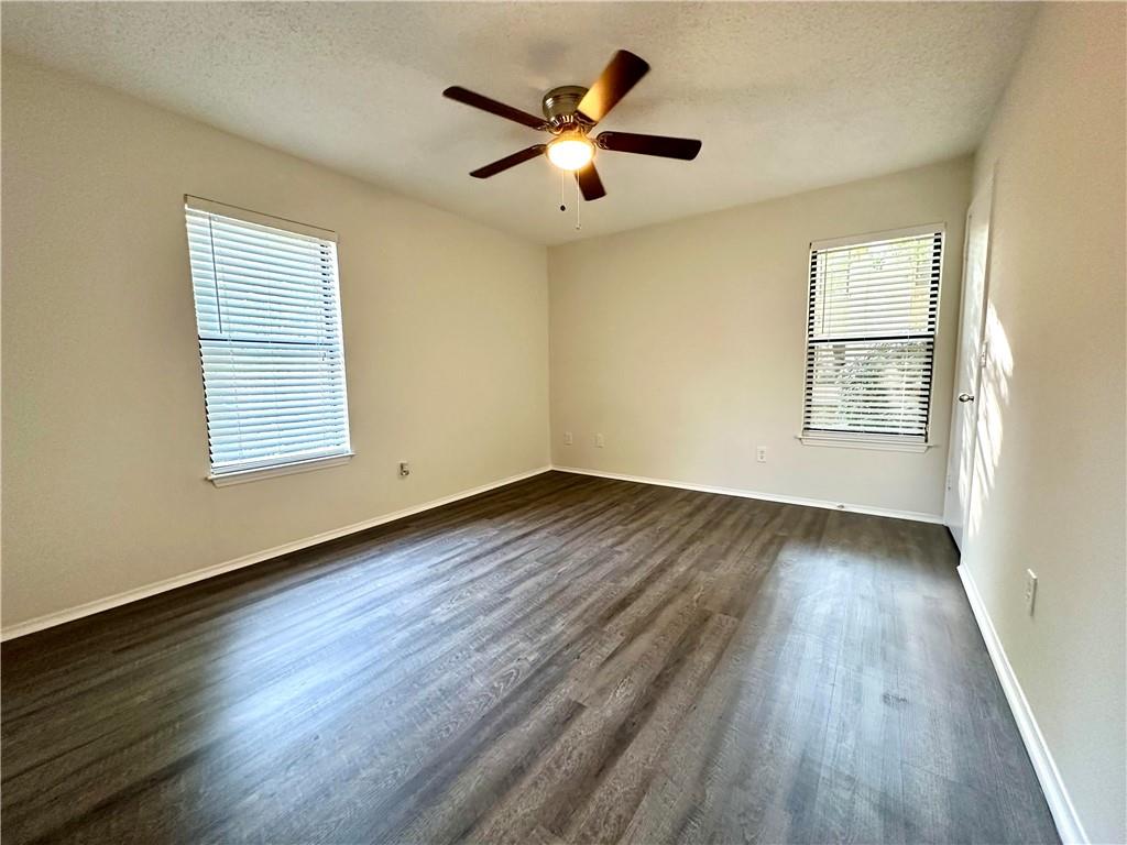 2301 Huntingdon Chase Atlanta, GA 30350 - Photo 7 of 15 a view of empty room with wooden floor and fan