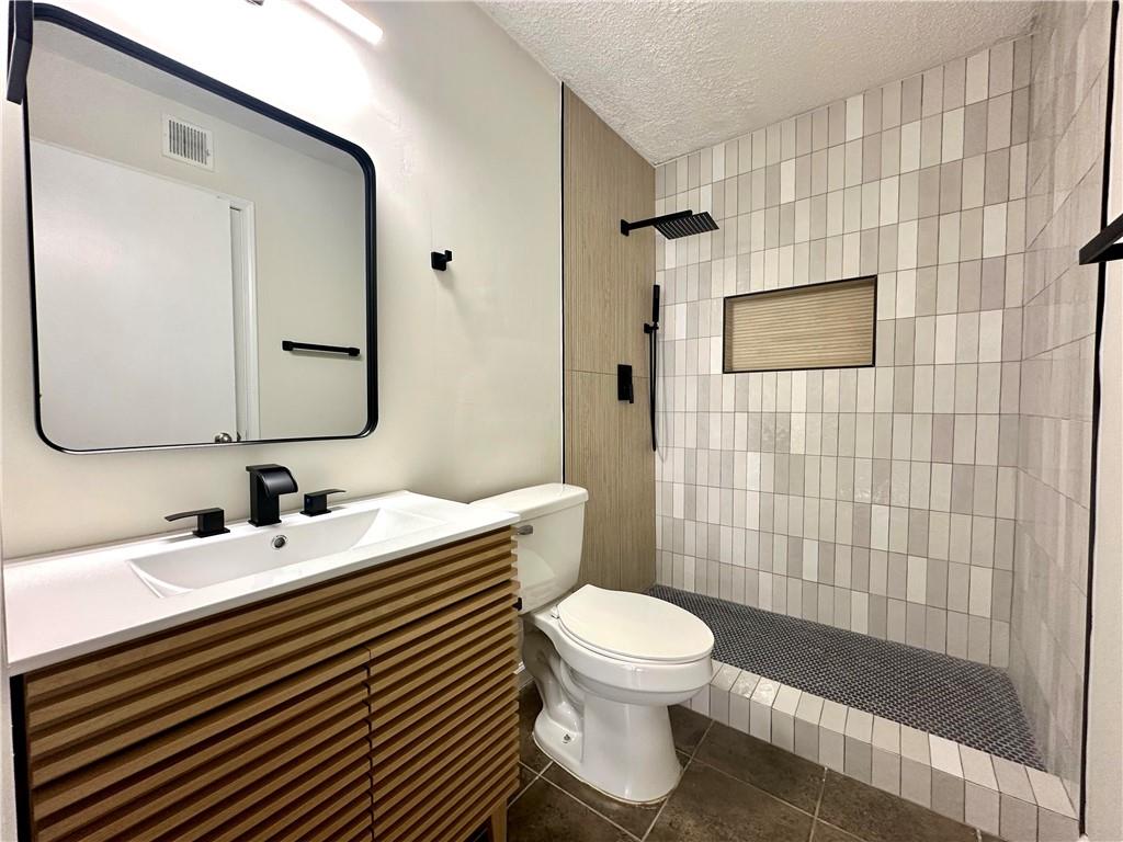 2301 Huntingdon Chase Atlanta, GA 30350 - Photo 9 of 15 a bathroom with a sink a toilet and shower