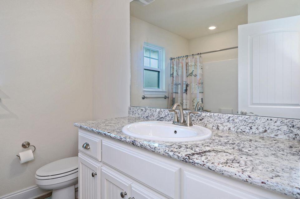 43 Brandywine Road Freeport, FL 32439 - Photo 11 of 23 a bathroom with a granite countertop sink a toilet and a mirror