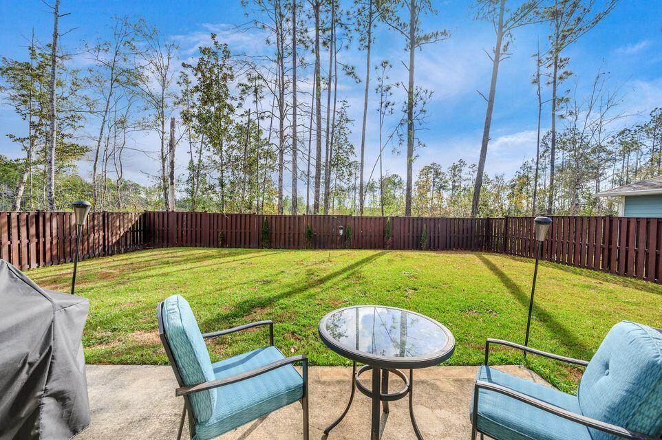 43 Brandywine Road Freeport, FL 32439 - Photo 16 of 23 a view of a backyard with a chair and table