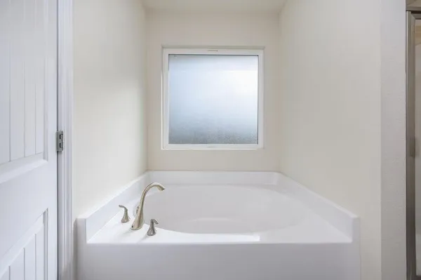 a white bath tub sitting next to a window