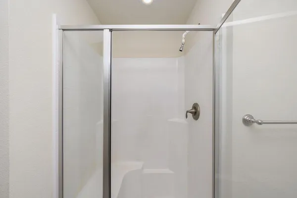 a bathroom with a glass shower door