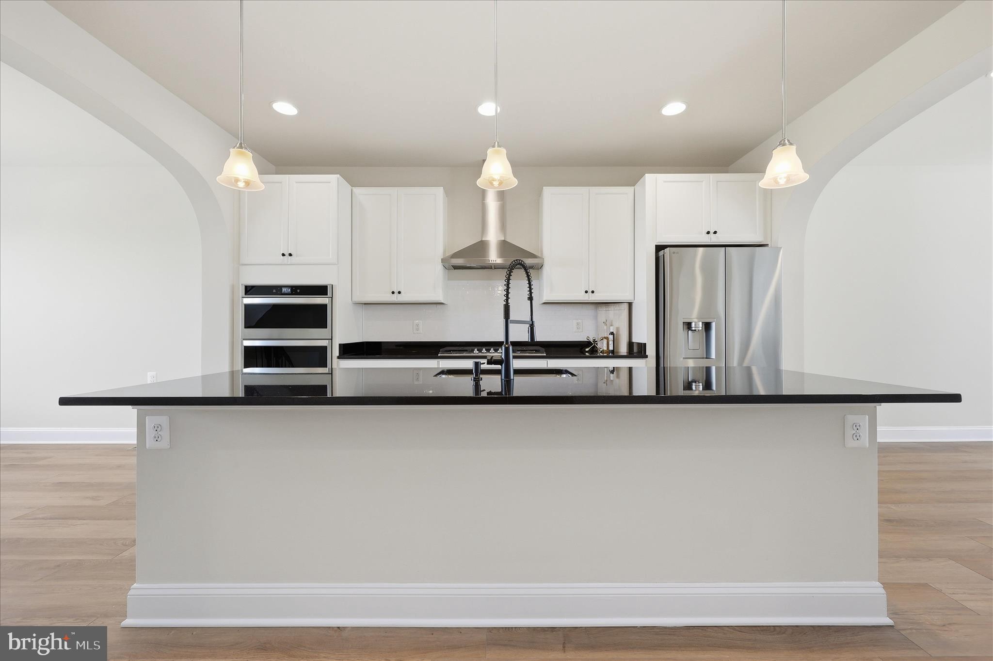 1090 Holden Road Frederick, MD 21701 - Photo 11 of 60 a view of a kitchen with kitchen island a sink stainless steel appliances and cabinets