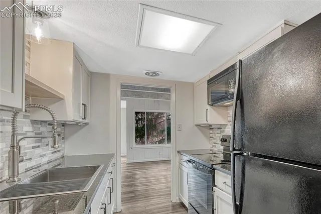 a kitchen with a sink stove and refrigerator