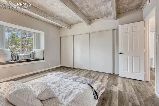 a bedroom with a bed and a window