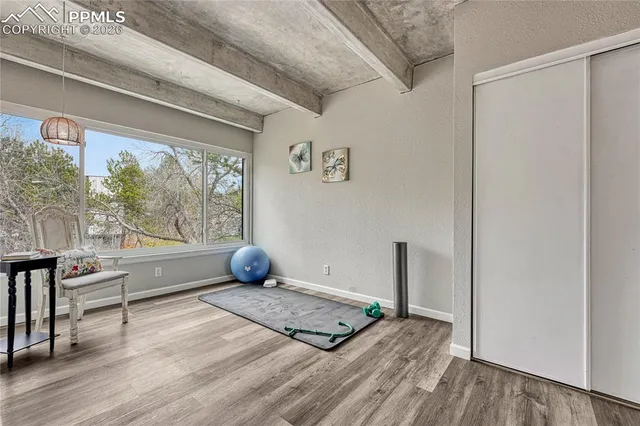 a view of a living room hardwood floor and wardrobe