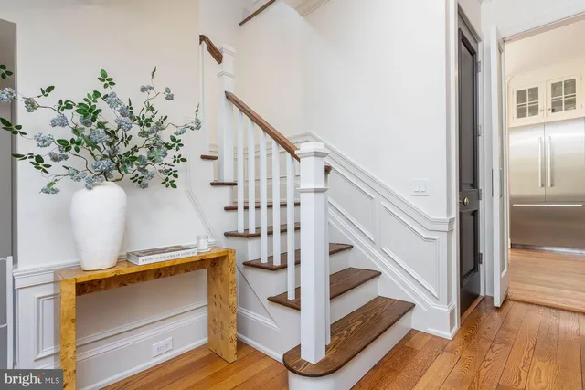 a dining room with furniture and a large window