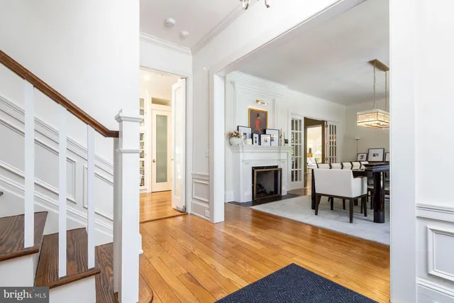 a dining room with furniture and a clock