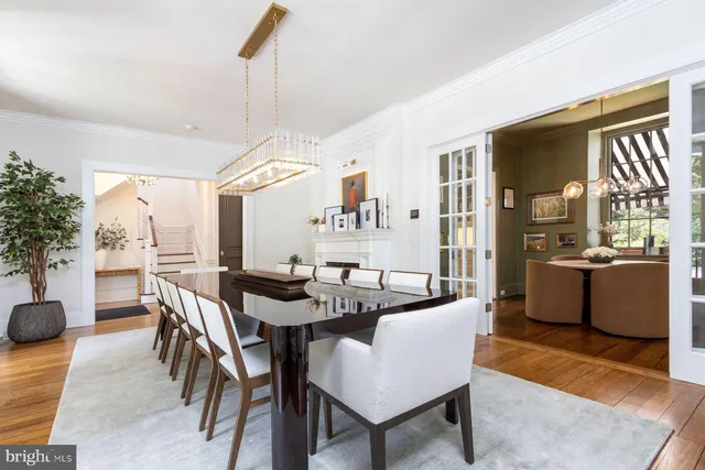 a room with kitchen island a sink and a stove next to a window