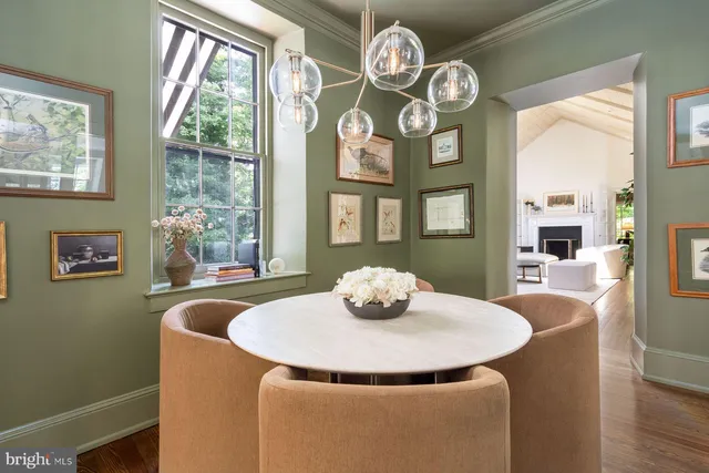 a living room with furniture a fireplace and a table