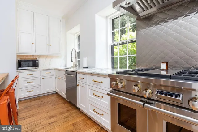 a dining room with furniture and a large window