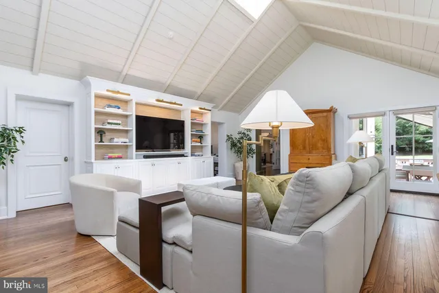 a bathroom with a tub a sink and mirror