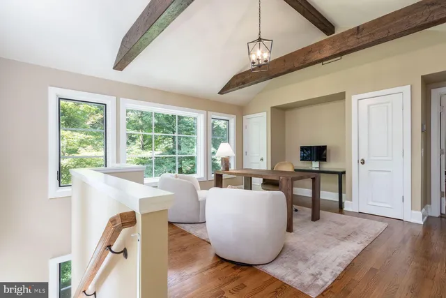 a bedroom with furniture and a mirror