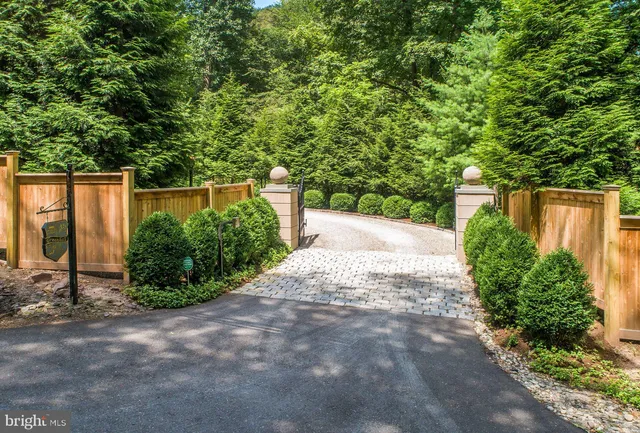 a front view of a house with yard and green space
