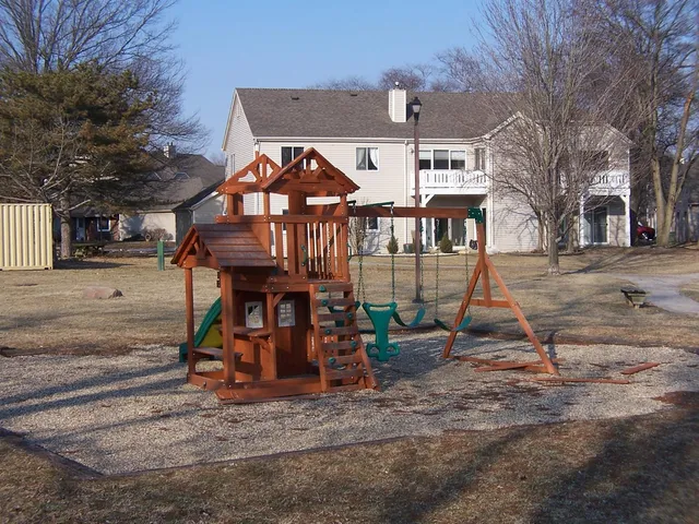 a view of a house with wooden deck