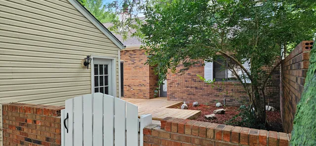 a view of a house with a tree front of house