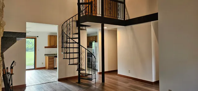 a view of an entryway with wooden floor