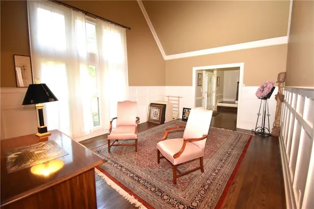 a view of an empty room window and wooden floor