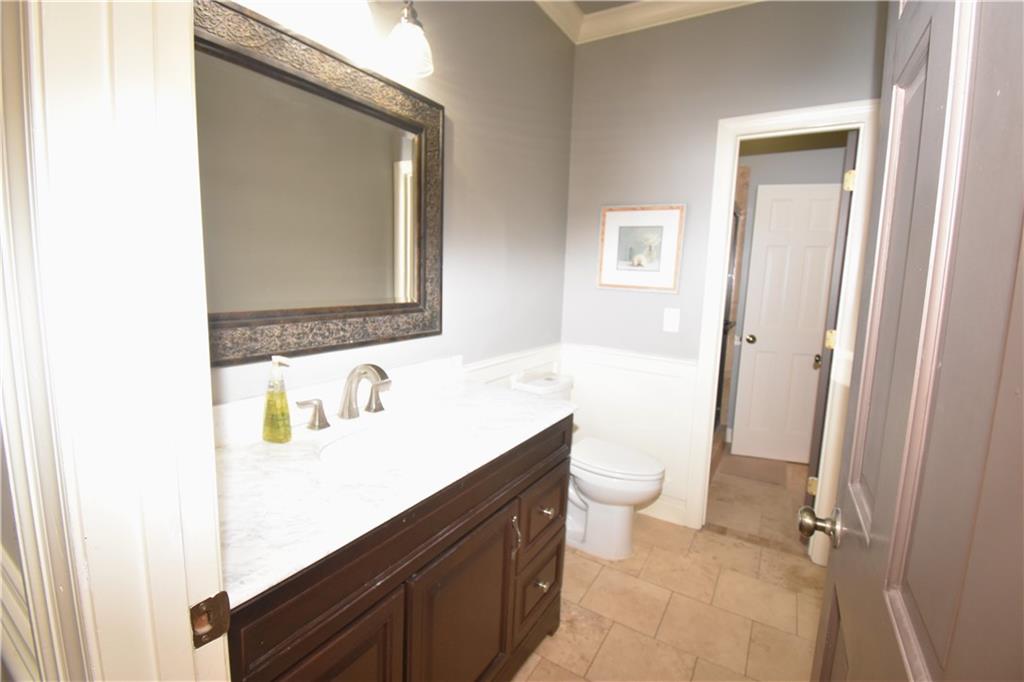 7700 Wickley Way Atlanta, GA 30350 - Photo 19 of 58 a bathroom with a sink a toilet a mirror and vanity