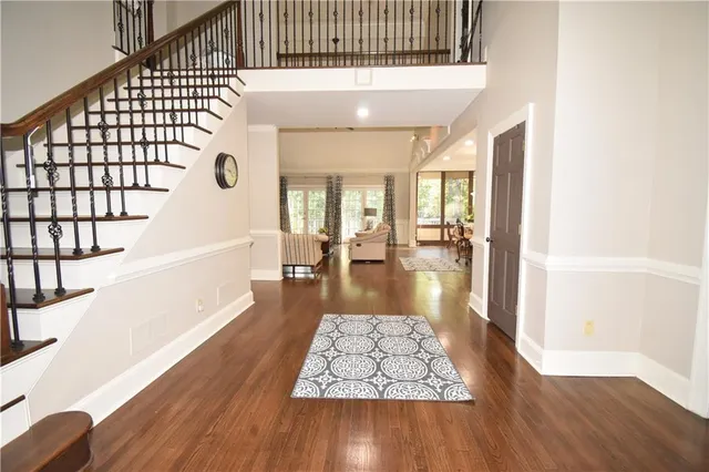 a view of entryway and hall with wooden floor