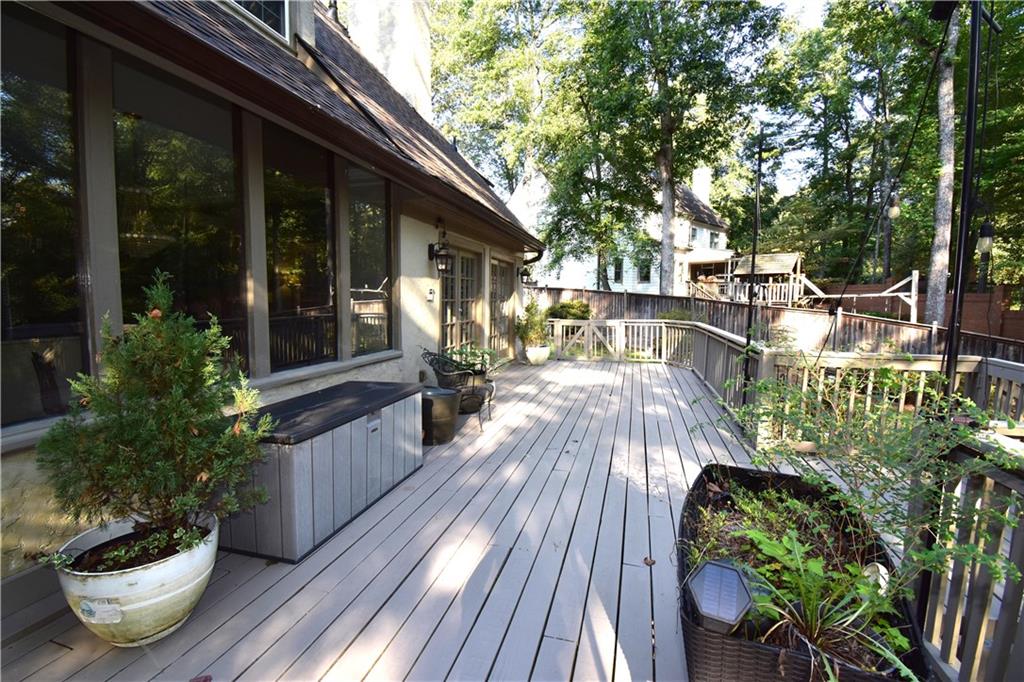 7700 Wickley Way Atlanta, GA 30350 - Photo 36 of 58 a view of a patio with table and chairs potted plants and floor to ceiling window