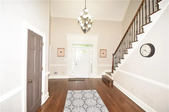 a dining room with furniture window and wooden floor