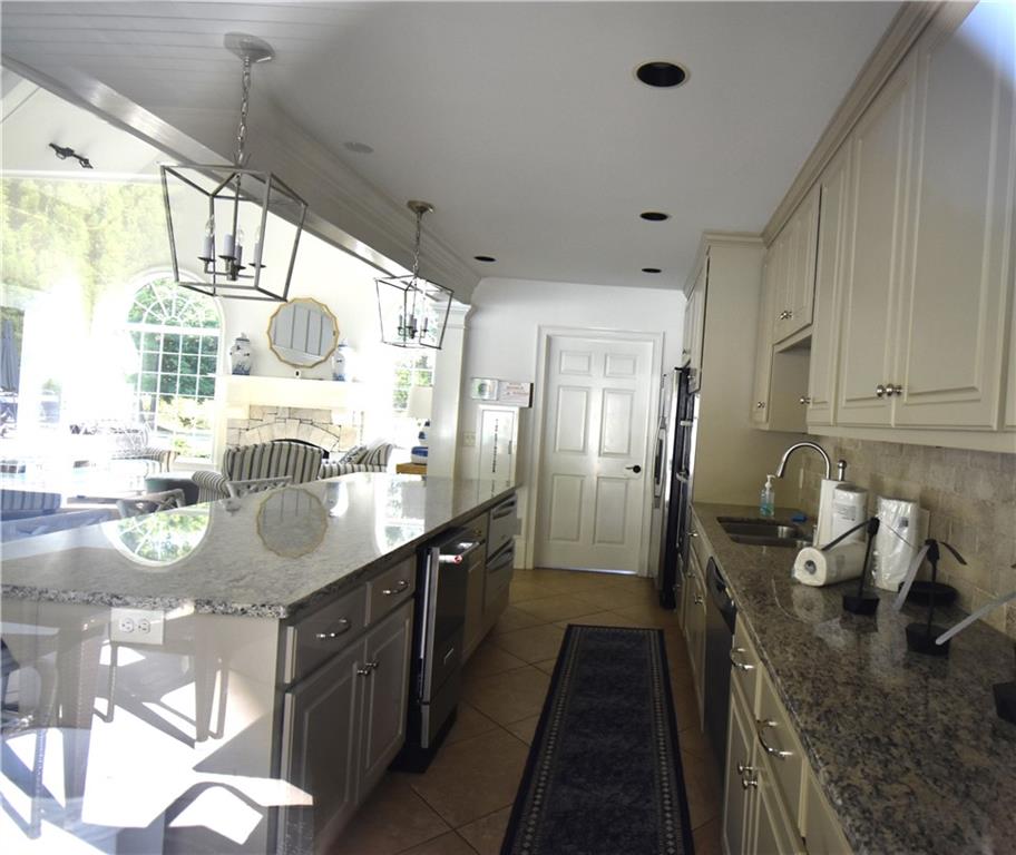 7700 Wickley Way Atlanta, GA 30350 - Photo 44 of 58 a kitchen with stainless steel appliances granite countertop a sink stove and refrigerator