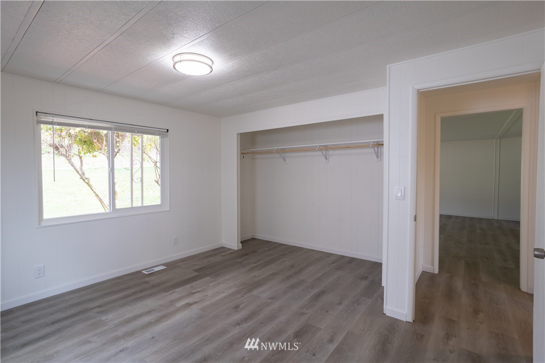 187 Senn Road Chehalis, WA 98532 - Photo 18 of 25 a view of an empty room with wooden floor and a window