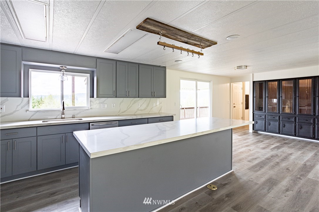187 Senn Road Chehalis, WA 98532 - Photo 3 of 25 a kitchen with stainless steel appliances granite countertop a sink counter space cabinets and a large window