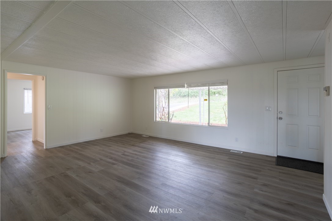 187 Senn Road Chehalis, WA 98532 - Photo 8 of 25 an empty room with wooden floor and windows