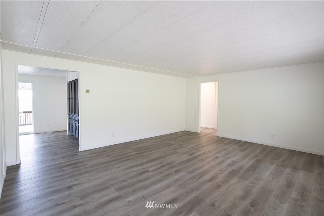 187 Senn Road Chehalis, WA 98532 - Photo 10 of 25 a view of an empty room with wooden floor and a window